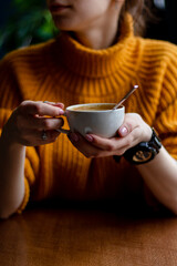 Woman in a cafe drinking coffee