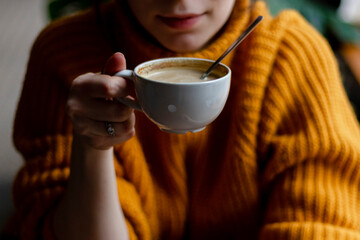 Woman in a cafe drinking coffee