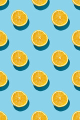 fruit pattern of fresh ripe slice oranges on blue background. top view