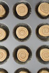 Morning rolls rounds in cupcake pan, raw morning buns or cinnamon rolls, raw dough before rise, flatlay of unbaked morning rolls or cinnamon rolls