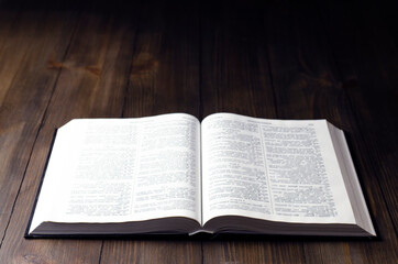 Open Bible. Open book. On a wooden background. Holy Bible.