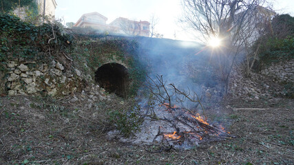 Bonfire burning wood in a fire pit during a gardening clean up session near Bar, Montenegro.