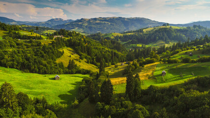 Aerial view of authentic traditional villages from Maramures area in Romania during sunny summer day