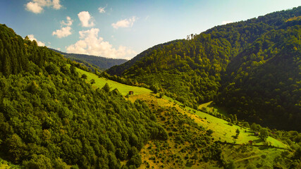 Aerial view of authentic traditional villages from Maramures area in Romania during sunny summer day