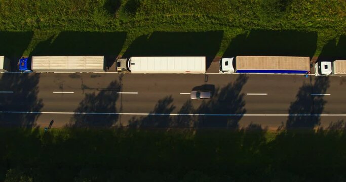 Aerial view: Big queue of trucks. Trucks wait in line for border crossing control. Top view.