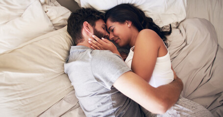 You're my safe space. Shot of an affectionate young couple embracing in bed at home.