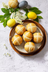 Easter baking. Homemade Easter traditional hot cross buns on a gray stone tabletop. Copy space.