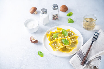 Fresh prepared Ravioli pasta with mushrooms and cheese in a plate