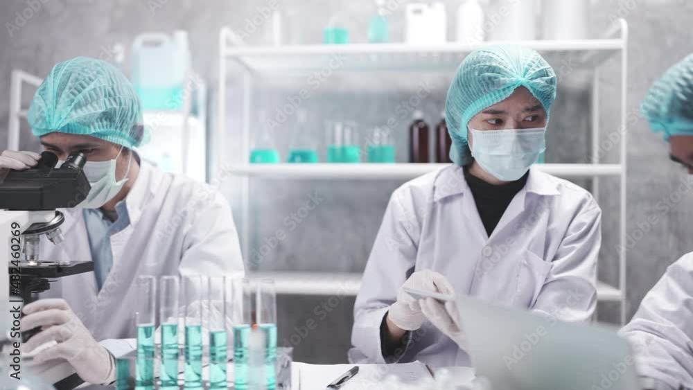 Wall mural medical scientist team are working on science laboratory research term by using microscope and scien
