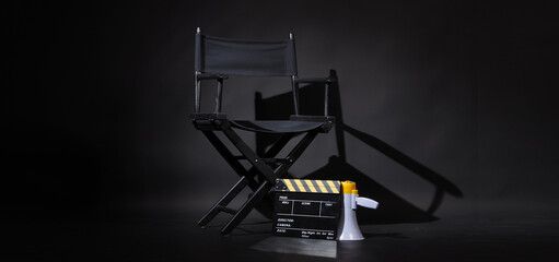 Black director chair and Clapper board or movie Clapperboard with megaphone on black background.use in video production or film cinema industry - obrazy, fototapety, plakaty