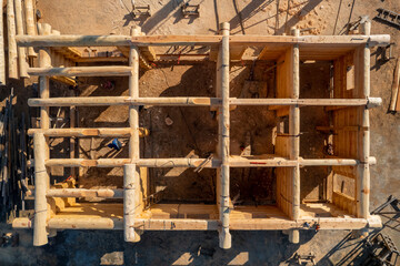 Construction industry concept. Timber wooden frame of house from bar, foundations of villas. Aerial top view