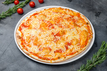 Italian pizza Margherita on plate on grey table