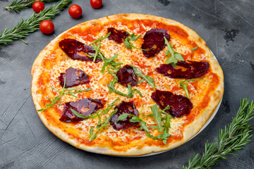 Pepperoni pizza on plate on grey table