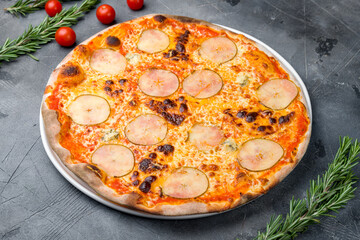 Pizza with pears and Gorgonzola cheese on grey table