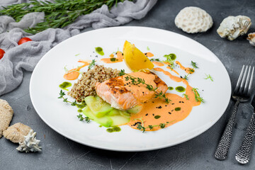 Salmon steak on the grill on white plate on grey table