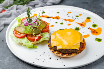 Open Burger with beef, cheese and vegetables on white plate