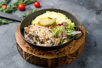 Stroganoff with mashed potatoes on grey table