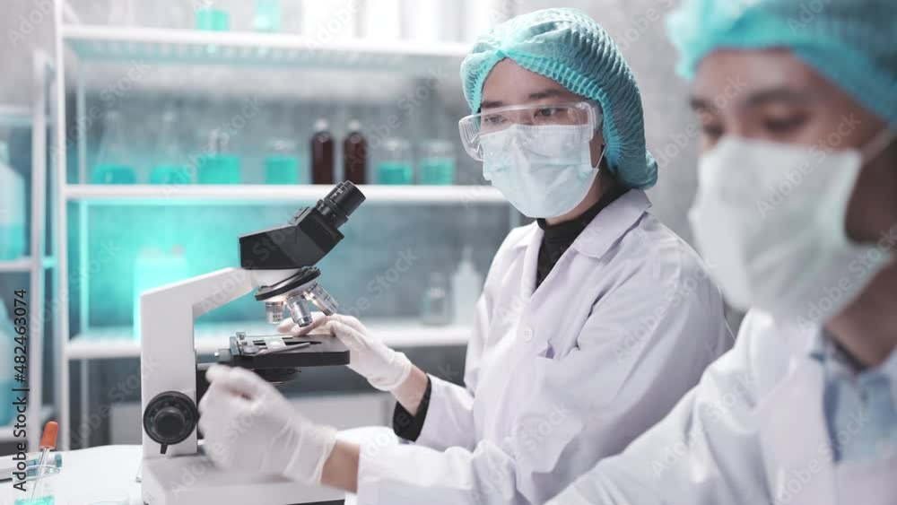 Wall mural medical scientist team are working on science laboratory research term by using microscope and scien