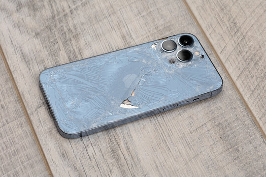 Rostov-on-Don, Russia - January 2022. Apple Iphone  13 Pro broken on the table. Broken phone back cover.