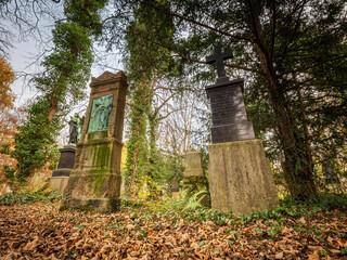 Fototapeta premium Tombstone cemetery tomb stone with autumn color background
