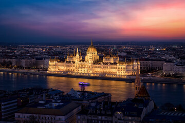 Fototapeta na wymiar Elevated view of the illuminated Hungarian Parliament Building at the river Danube in Budapest during a colorful evening