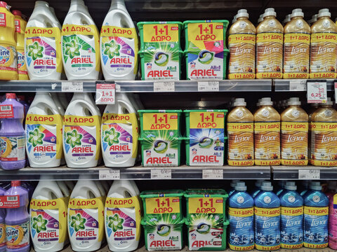 Ariel and Lenor products on supermarket sale. Store interior with plastic bottles of laundry detergent and fabric softener washing liquids on display.