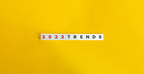 Trends for 2022 concept. Letter tiles on bright orange background. Minimal aesthetics.