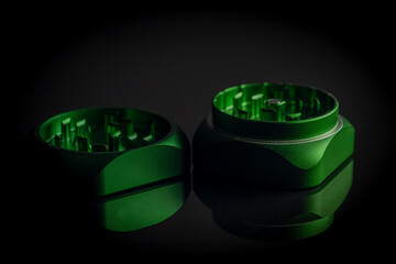 Green metal grinder with bounce on black sleek table