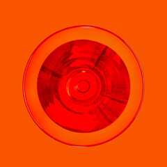 cocktail glass filled with drink top view on orange background