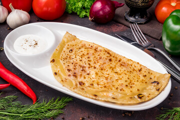 plate with Qutab on dark table side view