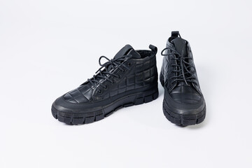 Men's leather short boots on a white background. Winter boots collection 2022