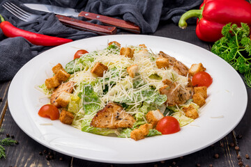 Salad caesar with chicken on white plate