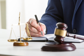 Lawyer working with contract papers and wooden gavel on tabel in courtroom. justice and law ,attorney, court judge concept.