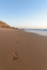 Footprints in the sand on the beach at sunset, Cape Trafalgar, Canos de Meca, Cadiz, Andalusia, Spain