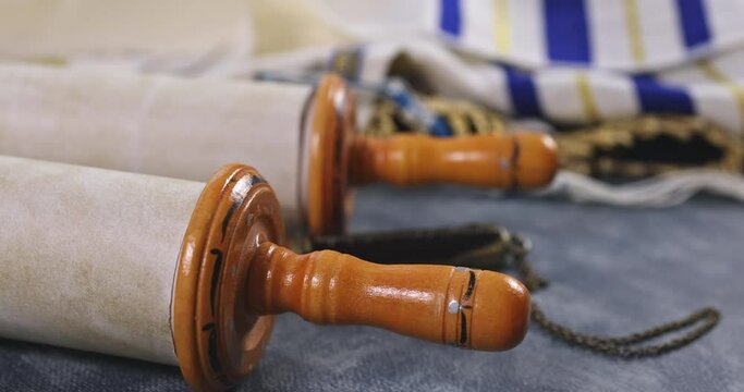 Jewish holidays symbol, during prayer items with shawl tallit on holy torah scroll in a synagogue