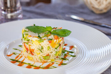 fried rice with vegetables on a white plate