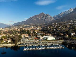 Aerial view beautiful panorama of Lake Como coastline and a pier full of sailboats