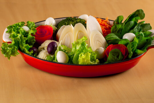 fresh salad tomatoes, olives, green leaves and palm hearts