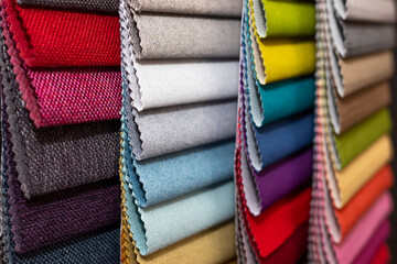 Colorful textile palette. Texture background. Multicolor upholstery fabric samples close-up shallow...