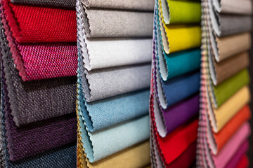 Colorful textile palette. Texture background. Multicolor upholstery fabric samples close-up shallow depth of field. Color selection