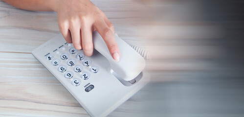 woman resetting home wired phone