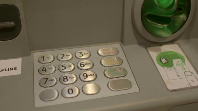 Close-up of hand enters a PIN or Personal Identification Number is a 4-digit code unique to each ATM card that ensures that the user or account holder is carrying out the transactions. 