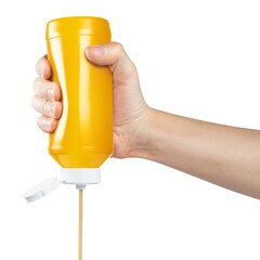 Hand squeezing mustard out of a plastic bottle, isolated on white background - obrazy, fototapety, plakaty