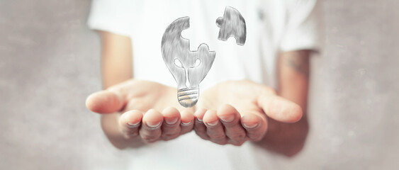hand drawn light bulb. a piece of the puzzle is split from the sweetheart. man holding open palms
