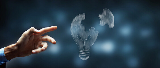 hand drawn light bulb. a piece of the puzzle is split from the sweetheart. man anzhit on the screen