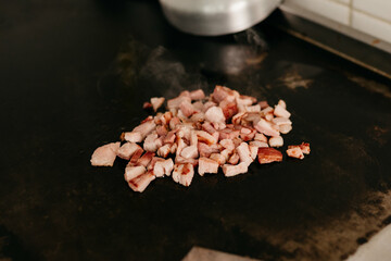 Fototapeta na wymiar Snack - Bacon frying on the plate