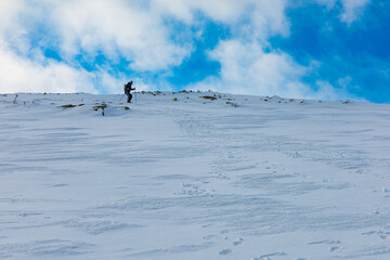 People walk down to the mountain making a new mountain trail full of fresh snow