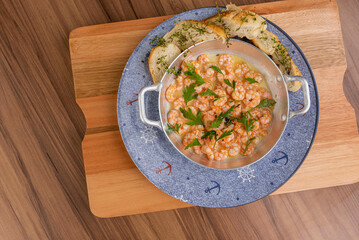 Shrimp in lemon sauce and portion of bread to accompany