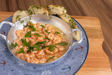 Shrimp in lemon sauce and portion of bread to accompany