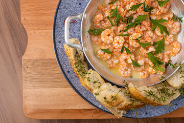 Shrimp in lemon sauce and portion of bread to accompany